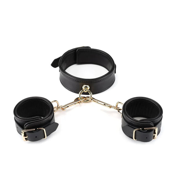 Premium black sheepskin leather bondage set with soft inner lining and gold metal hardware, including collar and handcuffs connected by gold chains