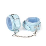 Sky-blue faux crocodile leather ankle cuffs with plush lining and adjustable silver buckles, part of the beginner's bondage kit