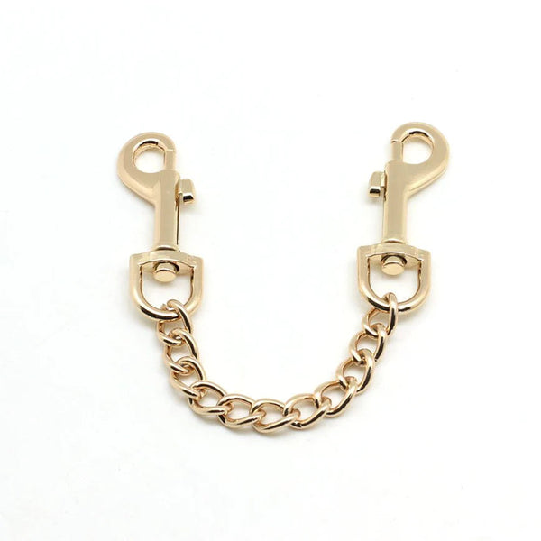 Rose gold quick release clip with chain for connecting cuffs, suitable for bondage play
