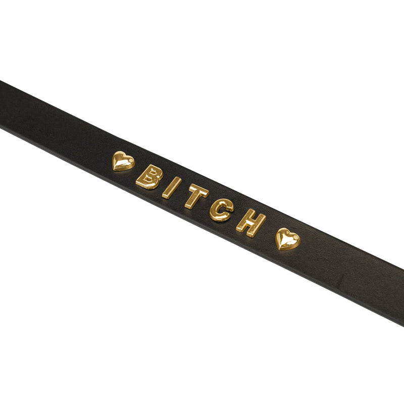 Gold word choker with 'BITCH' inscription in gold letters on black leather, bordered by gold hearts