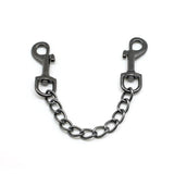 Gun metal quick release clip with connected chain for bondage gear, durable material, shown against a white backdrop