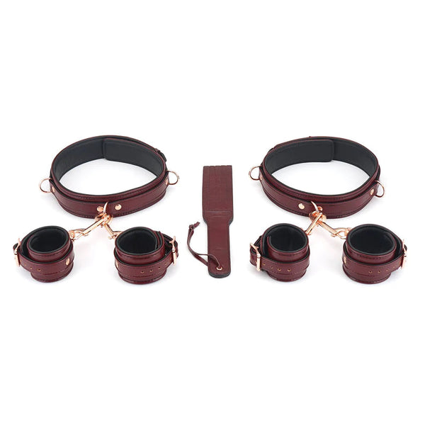 Wine red leather BDSM restraint kit with thigh cuffs, wrist cuffs, ankle cuffs, and central connector strap, finished with rose gold hardware