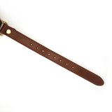 Adjustable dark brown leather strap with vintage gold buckle detail, part of The Equestrian leather bondage collection