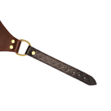 Close-up of adjustable leather strap with vintage gold buckle and quilted detailing from The Equestrian BDSM leather panties collection