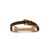 Luxury leather pony play gag with dark brown strap, vintage gold hardware, and removable wooden bit from The Equestrian collection