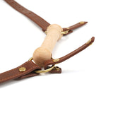 Close-up of The Equestrian leather blinder and bite gag with vintage gold metal hardware, perfect for pony play fantasies