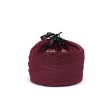 Dark red velvet cylindrical bondage toy storage bag with black drawstring and Liebe Seele logo