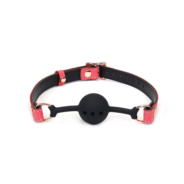 Pink leather strap ball gag with breathable silicone ball and rose gold hardware from the Angel's & Demon's Kiss Bondage Collection