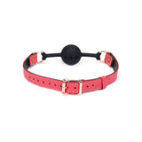 Pink leather ball gag with breathable silicone ball and rose gold hardware from Angel's & Demon's Kiss Bondage collection.
