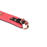 Cherry blossom pink leather ankle cuff with rose gold heart-shaped hardware and ostrich skin pattern from Angel's Kiss collection