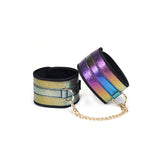 Multicolored holographic wrist cuffs with golden chain from the Vivid Niji bondage kit, showcasing beginner-friendly BDSM gear