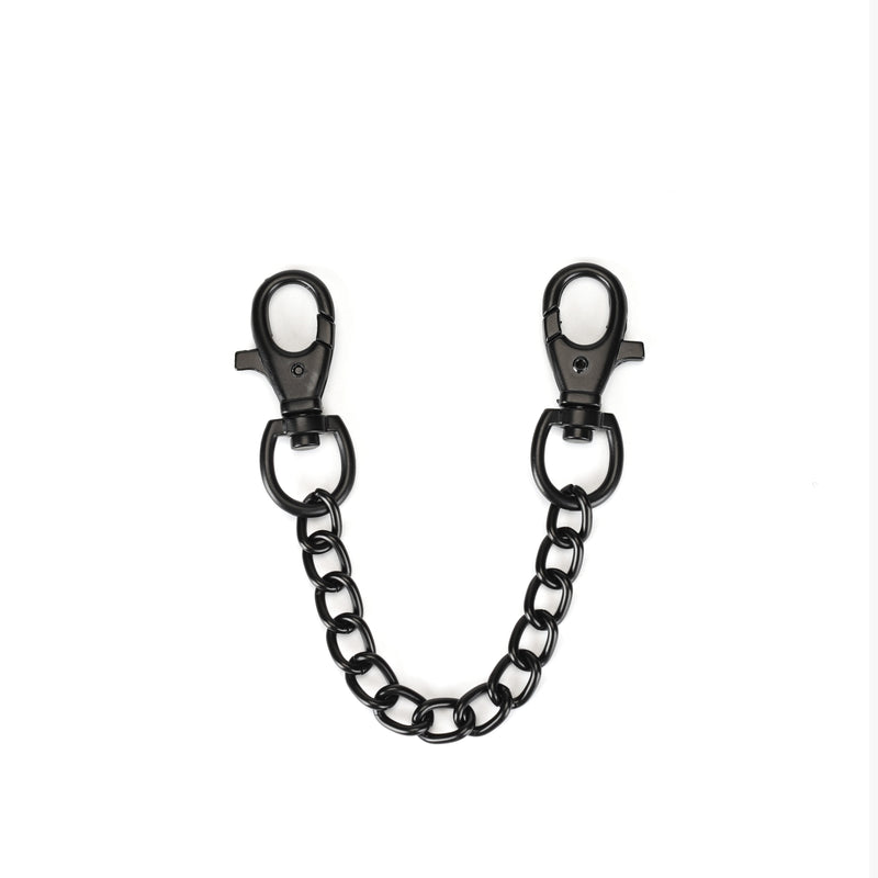 Black metal quick-release clips linked by a chain, designed for secure and adjustable connection in vegan leather ankle cuff bondage play