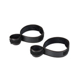 Black vegan leather wrist-to-thigh restraints with adjustable Velcro fittings part of vegan bondage accessories