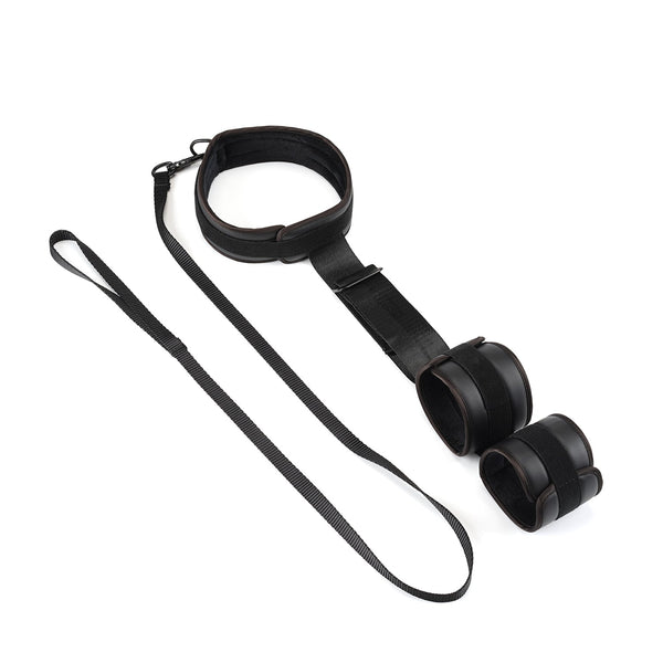 Vegan leather wrist-to-collar restraints in black with detachable leash for BDSM and puppy play, made from faux leather