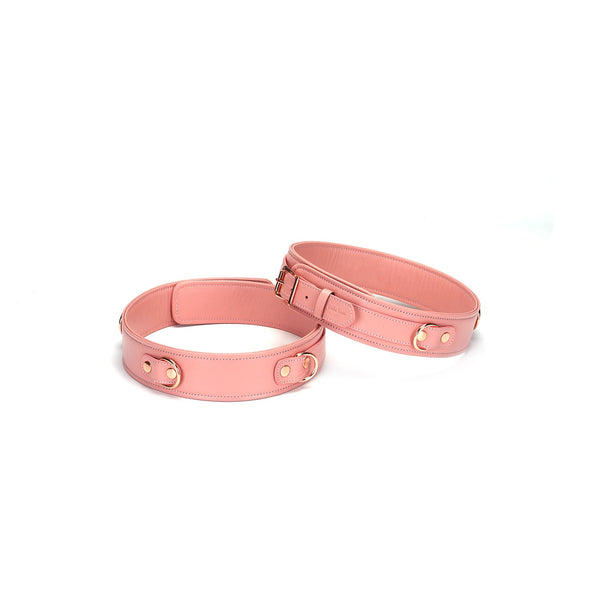 Pink Dream leather thigh cuffs with rose gold hardware and adjustable buckle for BDSM play.