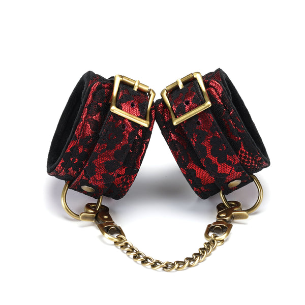 Victorian Garden lace and vegan leather ankle cuffs in red and black with brass chain and buckles, suitable for BDSM roleplay