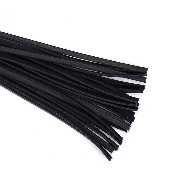Close-up of black leather fronds of a luxurious BDSM flogger, highlighting the texture and quality