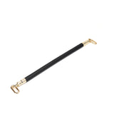 Black leather-coated spreader bar with golden hardware, designed for enhanced restraint play in bondage, part of the Dark Secret collection