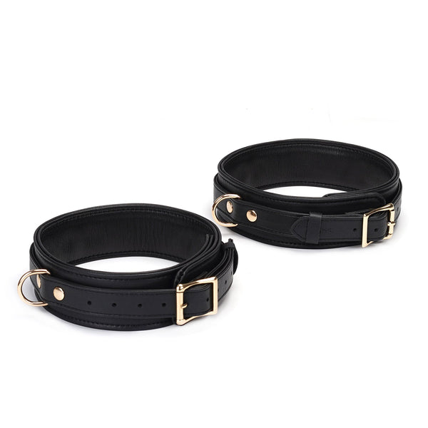 Leather thigh cuffs with gold hardware from the Dark Secret collection, adjustable and luxurious bondage accessories