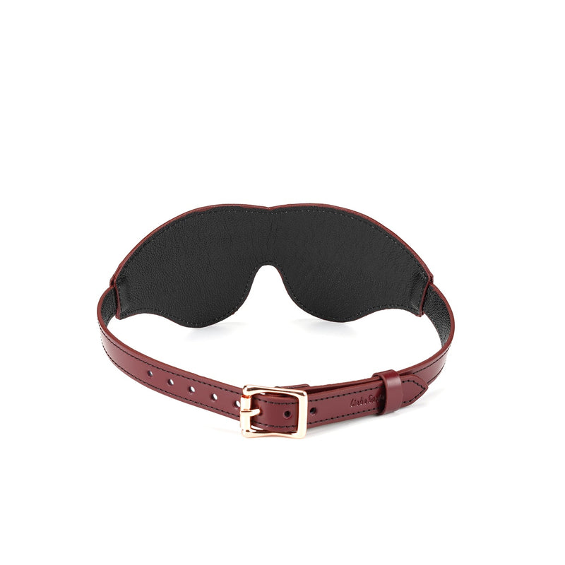 Wine Red leather blindfold with rose gold buckle for erotic sensory deprivation, part of luxury bondage gear collection