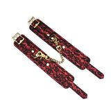 Red and black Victorian Garden lace bondage ankle cuffs with brass D-rings and connecting chain, essential for elegant BDSM roleplay
