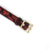 Close-up of Victorian Garden lace-covered red vegan leather bondage collar with brass buckle
