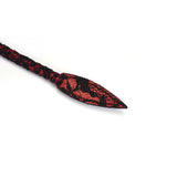 Close-up of Victorian Garden ruby-red and black lace-coated bullwhip tip, perfect for BDSM play