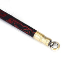 Close-up view of Victorian Garden lace and vegan leather spreader bar with gold quick-release clip, designed for BDSM play