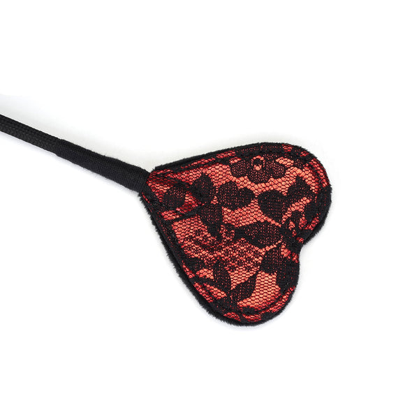 Heart-shaped tip of Victorian Garden lace and vegan leather riding crop for BDSM play