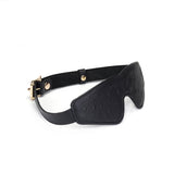 Black leather blindfold with ostrich skin pattern and rose gold buckle from Angel's & Demon's Kiss Bondage collection