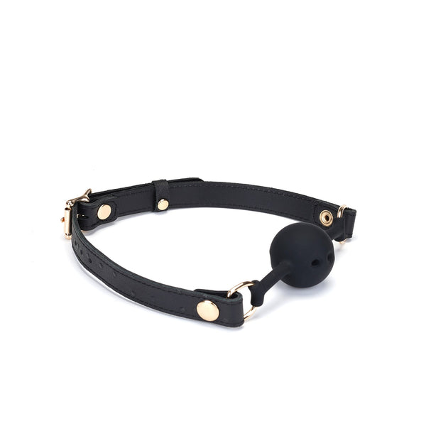 Demon's Kiss breathable silicone ball gag with black leather straps and gold metal hardware, featuring a luxurious ostrich skin pattern for BDSM play
