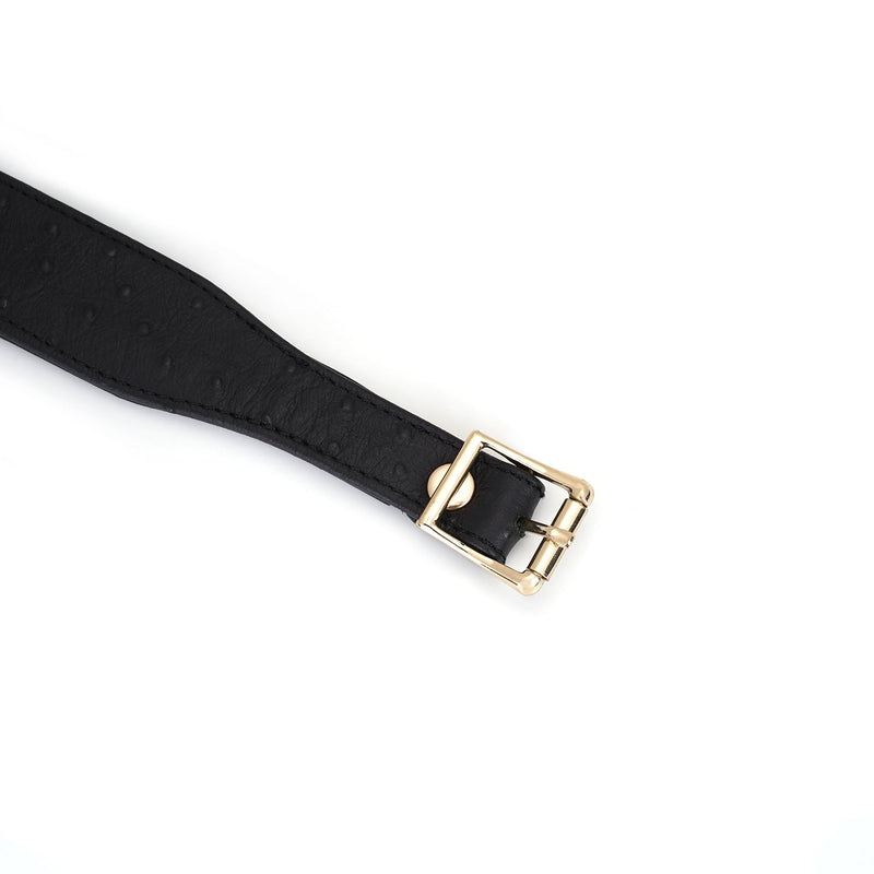 Luxurious black leather bondage collar with ostrich skin pattern and gold buckle, part of the Demon's Kiss collection