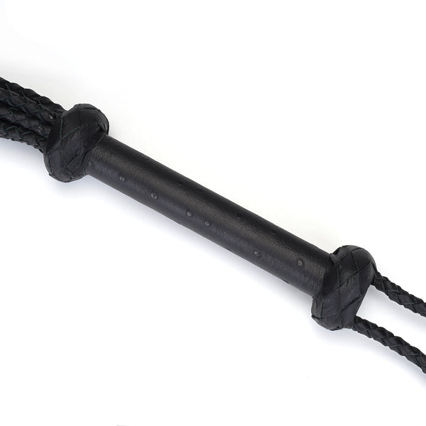 Luxurious black leather cat o' nine tails flogger handle with braided extensions for BDSM impact play, from the Demon's Kiss collection