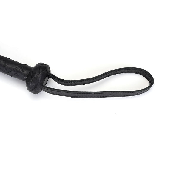 Close-up of black leather bullwhip tip with braided design, part of the Demon's Kiss bondage accessory collection