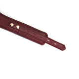 Close-up of Wine Red leather bondage collar with adjustable holes and rose gold buckles for BDSM play