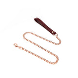 Wine red leather collar with rose gold chain leash for bondage play, showcasing high-quality craftsmanship and luxurious design