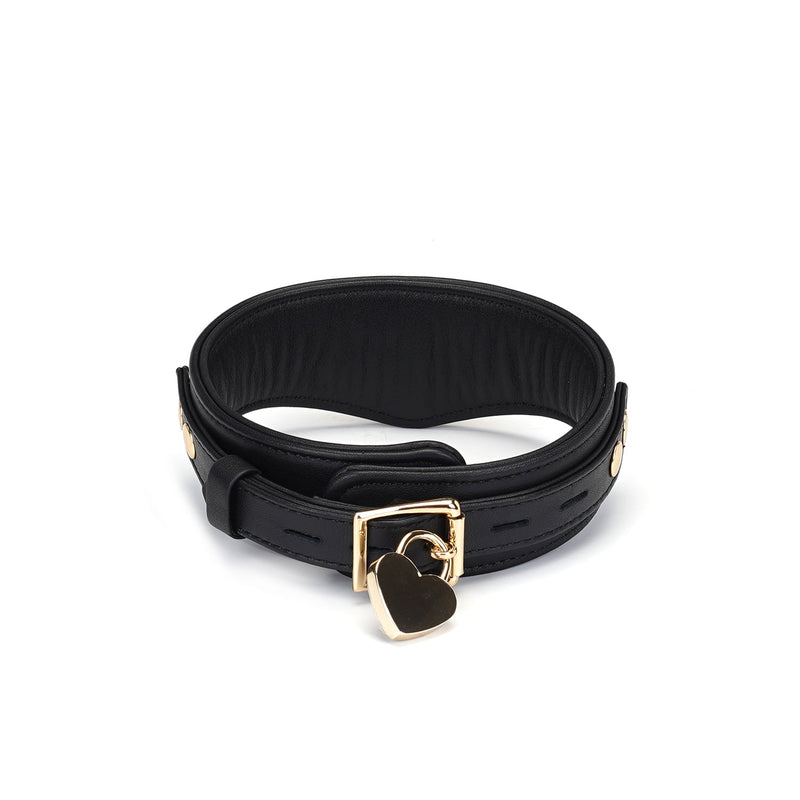 Premium black leather slave collar with golden heart-shaped lock and buckle from the Dark Secret collection, designed for bondage play