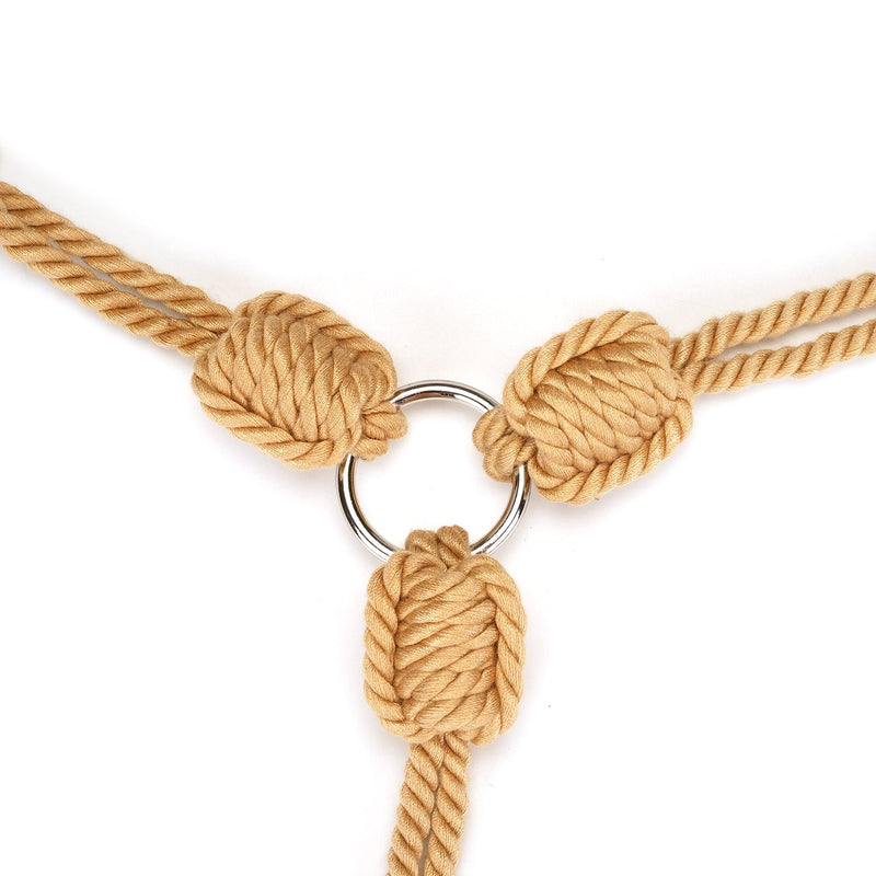 Khaki shibari rope with wrist-to-collar restraint and silver ring for bondage play.