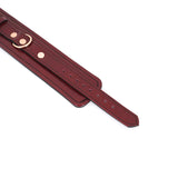 Wine red leather bondage handcuffs with rose gold hardware, featuring adjustable settings for erotic play