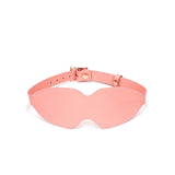Baby pink leather bondage blindfold with rose gold buckle, adjustable strap for sensual deprivation play