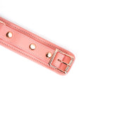 Pink leather bondage collar with rose gold buckle and adjustment holes, part of the Pink Dream collection for stylish restraint play