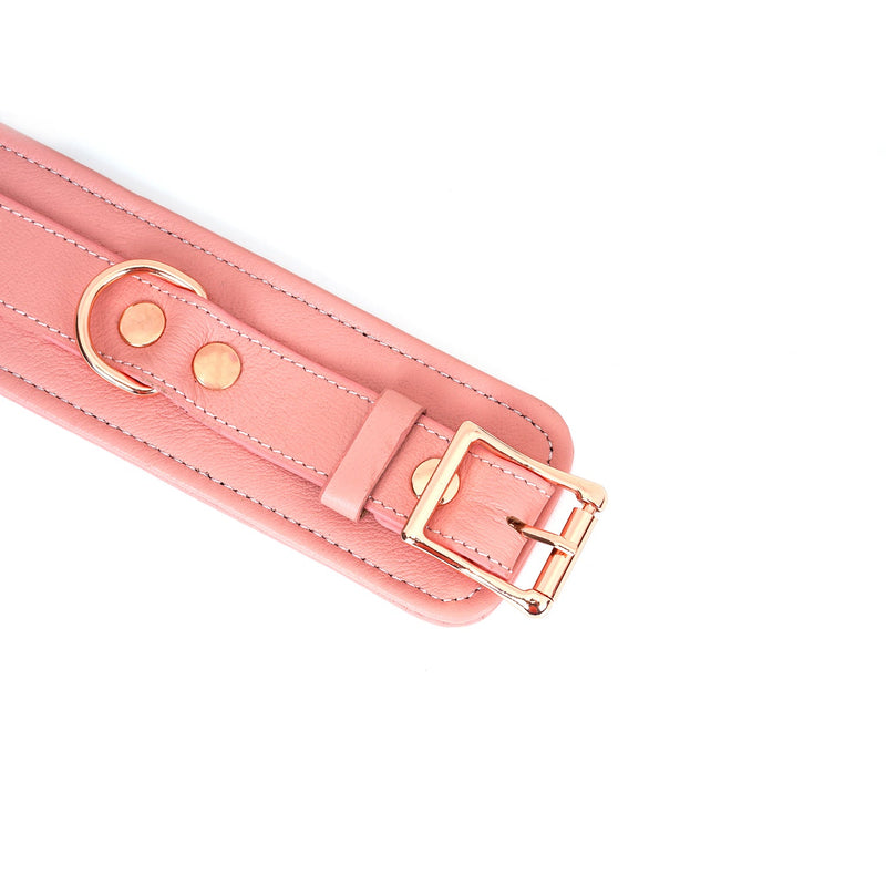 Pink leather handcuff with rose gold buckle and hardware, part of the Pink Dream bondage collection