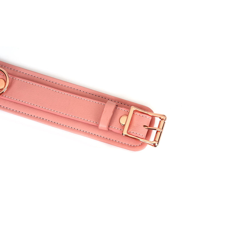 Baby pink leather thigh cuff with rose gold buckle and D-rings from the Pink Dream bondage collection, designed for stylish and comfortable restraint play