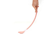 Person holding Pink Dream leather riding crop with heart-shaped tip for BDSM play
