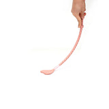 Person holding Pink Dream leather riding crop with heart-shaped tip for BDSM play