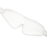 White leather padded blindfold from Fuji White collection, featuring adjustable strap and detailed stitching for sensory play in BDSM