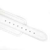 Close-up view of Fuji White leather handcuffs with adjustable holes and silver metal hardware for BDSM play