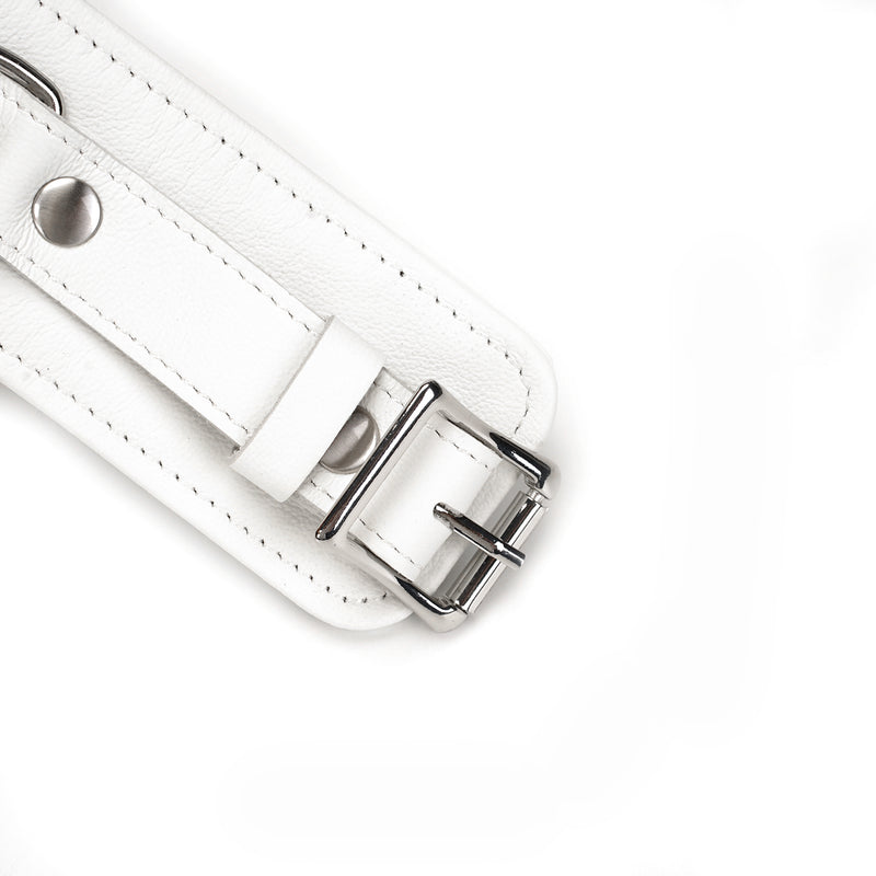 Close-up of Fuji White Leather Handcuffs featuring silver metal hardware and detailed white leather strap, designed for bondage play and wrist restraint
