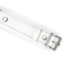 Close-up of white leather thigh cuff with silver buckle and D-rings from Fuji White bondage collection