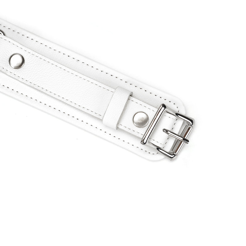 Close-up of white leather thigh cuff with silver buckle and D-rings from Fuji White bondage collection